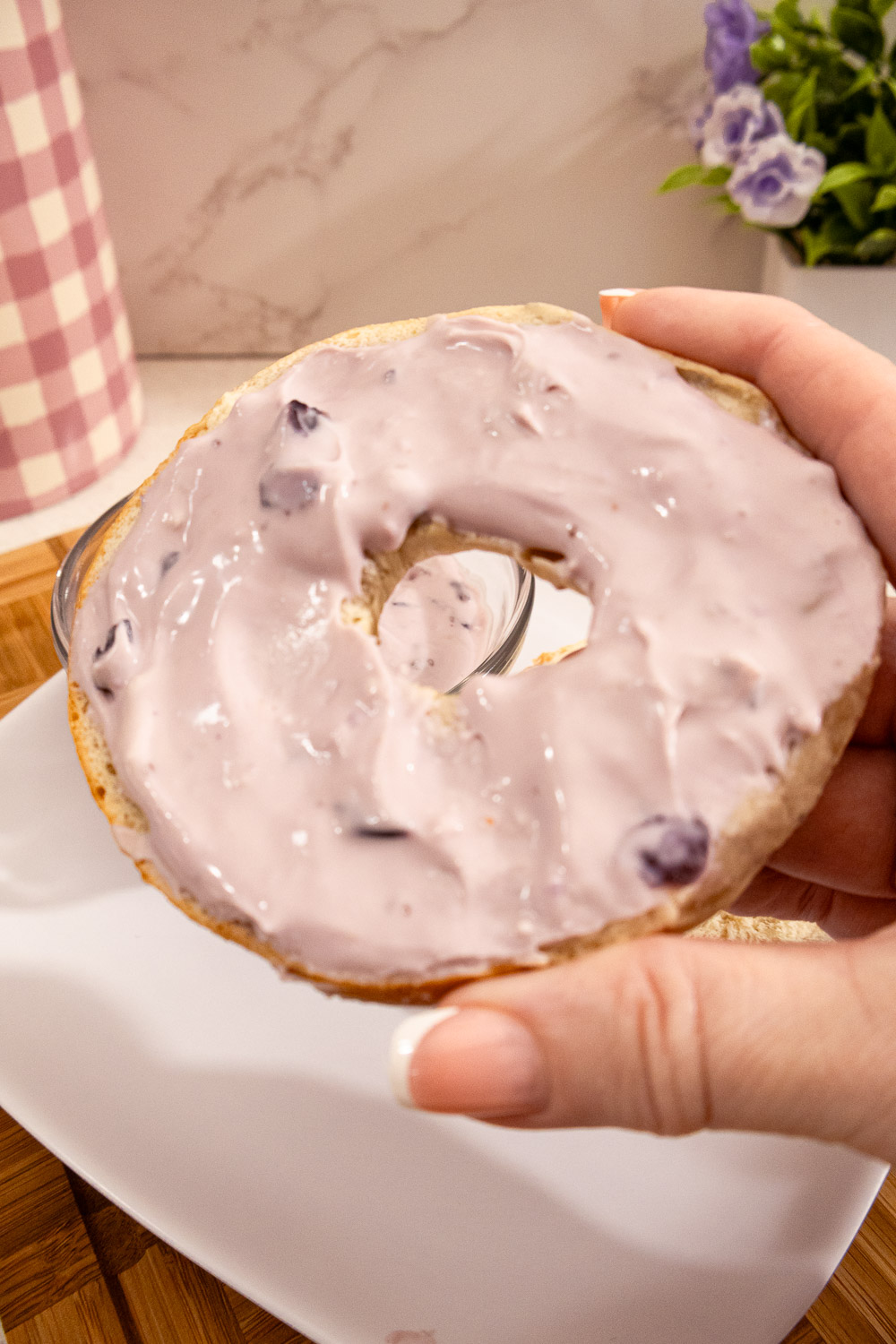 Close-up of homemade blueberry cream cheese spread on a blueberry bagel