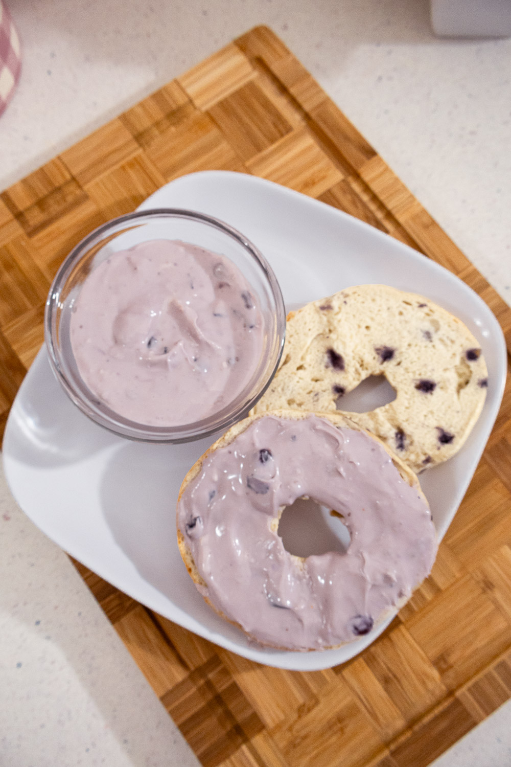 Overhead view of homemade blueberry cream cheese spread with blueberry bagels