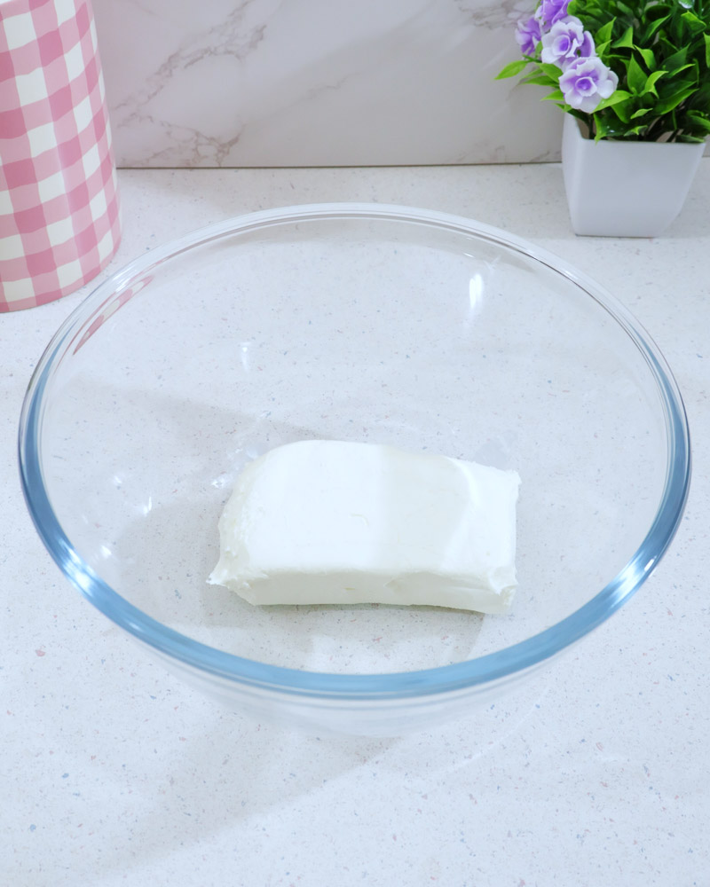 Glass bowl with softened cream cheese