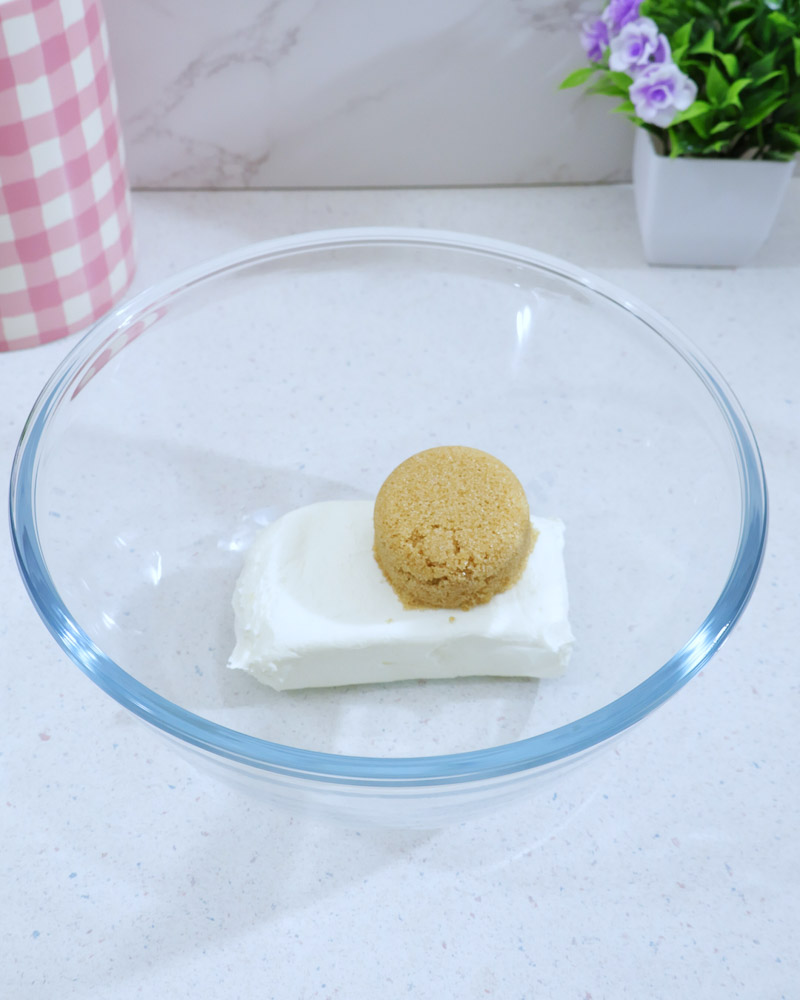 Glass bowl with softened cream cheese and brown sugar