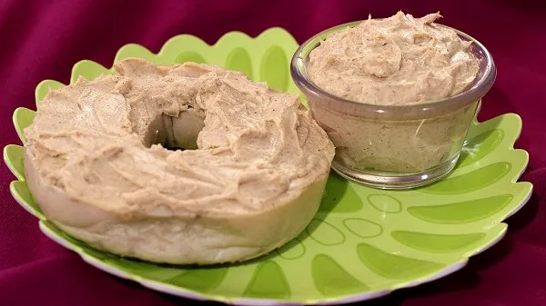 Sweet brown sugar cinnamon cream cheese spread on a fresh bagel and in a glass bowl