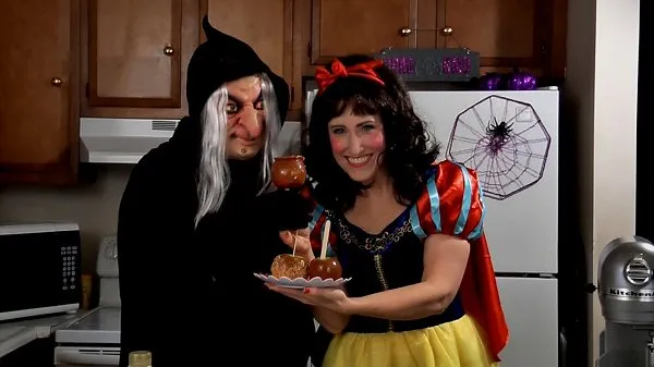 Amy Lynn and Frankie in Halloween costumes holding caramel apples.