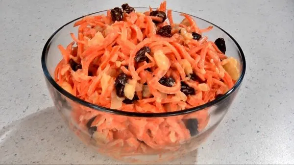 A clear bowl of fresh, homemade carrot raisin salad.