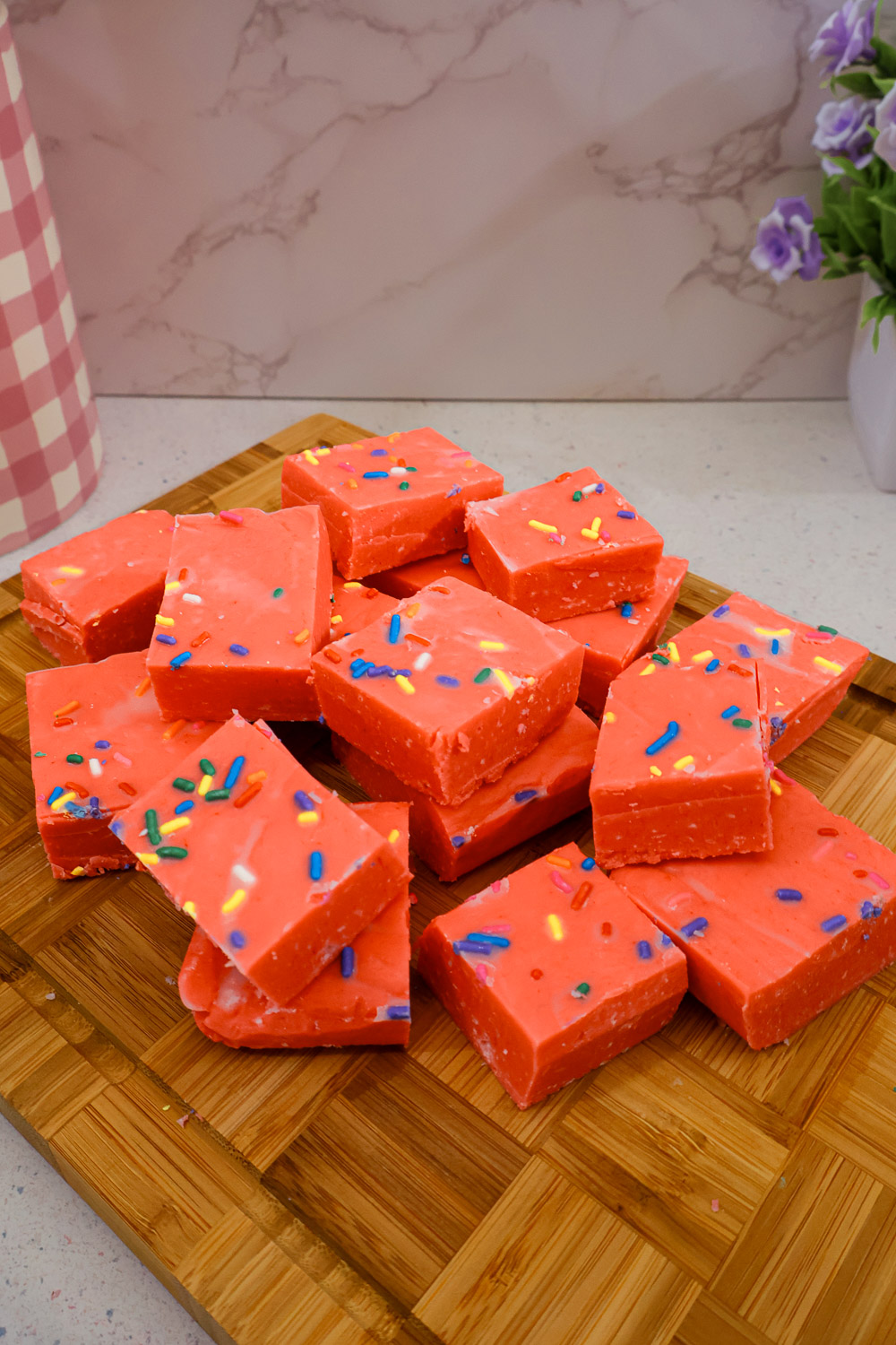 Cherry Kool-Aid fudge squares topped with colorful sprinkles