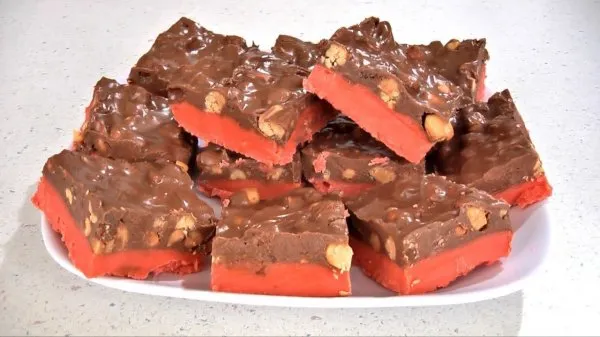 Stacked festive cherry mash bars on a white plate.