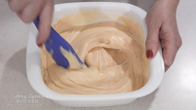 In a microwave safe bowl, melt white chocolate chips and sweetened condensed milk in the microwave.