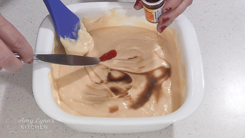 Add orange and vanilla extracts and orange gel food coloring.