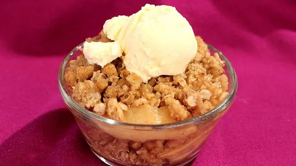 A bowl of easy apple crisp topped with ice cream.