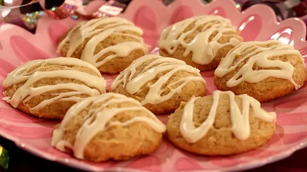 Eggnog Cookies with creamy glaze, stacked on a festive plate - soft holiday cookies with warm spices and a sweet eggnog finish.