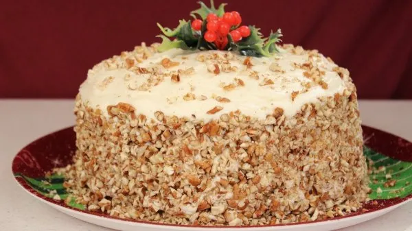 Italian cream cake on a holiday platter topped with mistletoe.