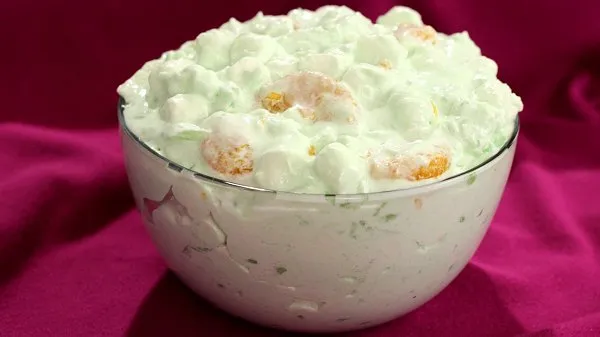 Bowl of lime fluff on a purple background.