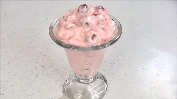 Pink stuff in a tall sundae bowl.