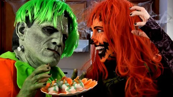 Orange plate of pumpkin spice buckeyes held by Amy Lynn and Frankie during Halloween.