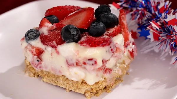 Slice of red, white and blue frozen dessert served on a white plate.