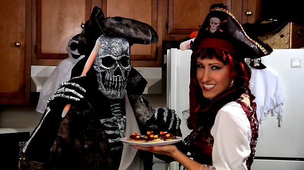 Photo of pirates holding a plate of candy corn fudge.