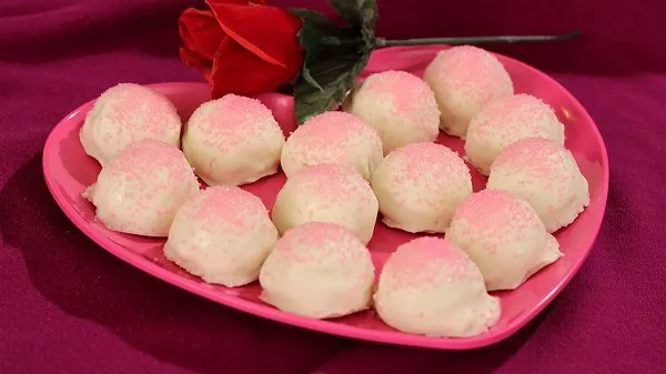 Valentine cheesecake truffles on a pink heart plate.