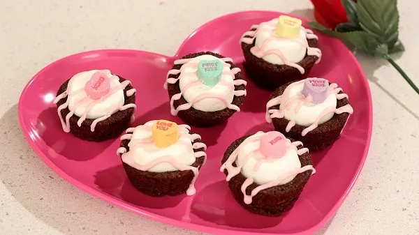 Valentine mini brownies topped with a large marshmallow, candy and drizzled with pink icing.